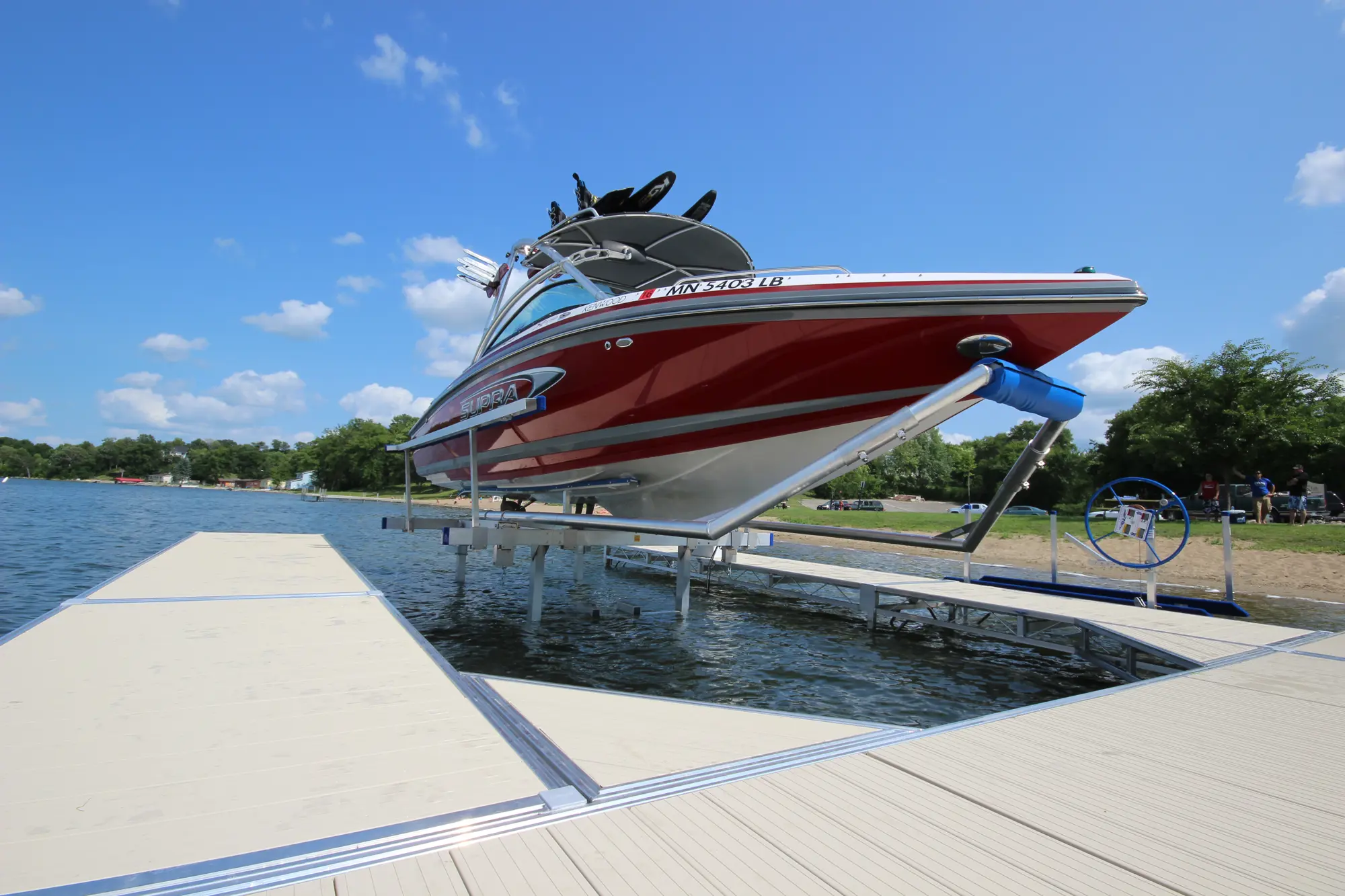 ShoreMaster boat lift beside a dock on the water