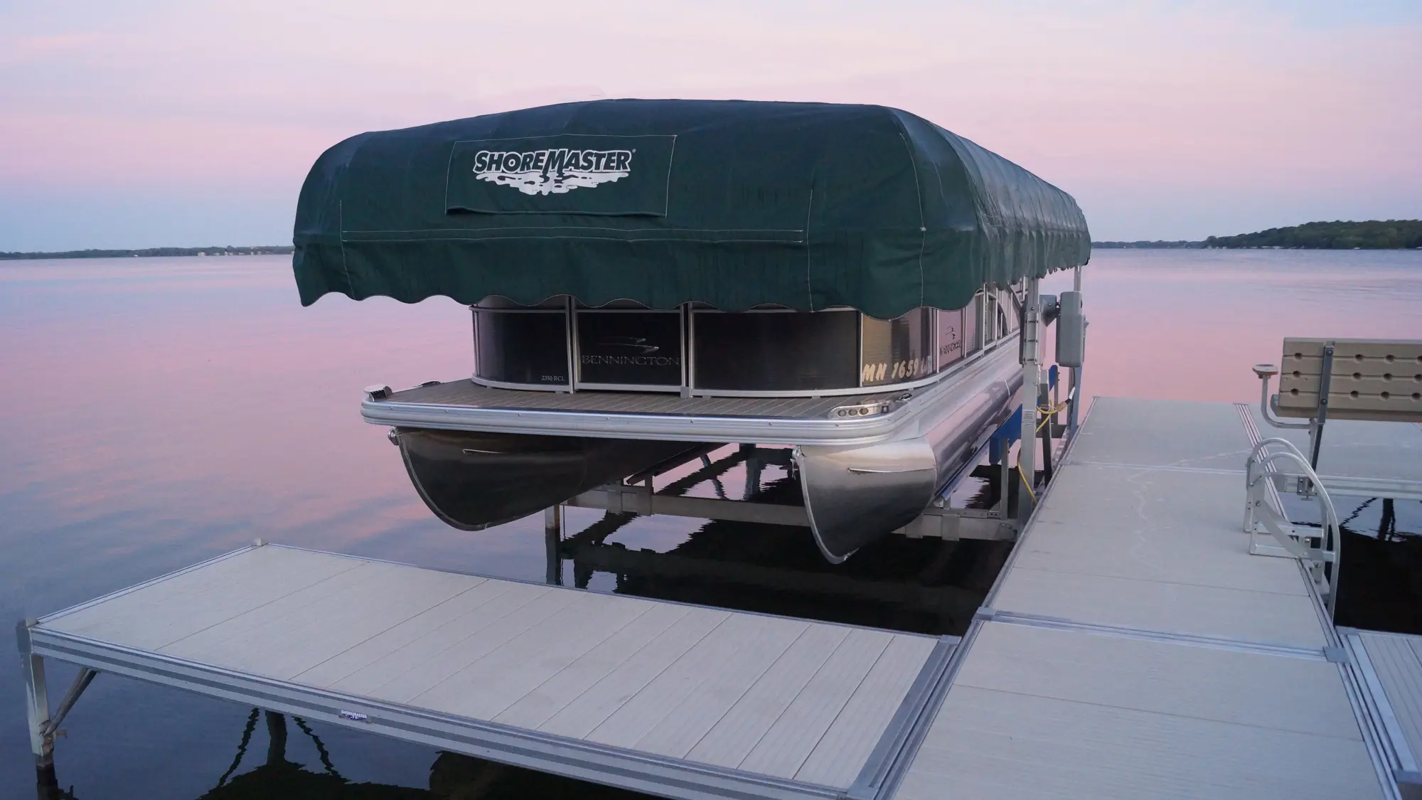 ShoreMaster vertical boat lift beside a dock