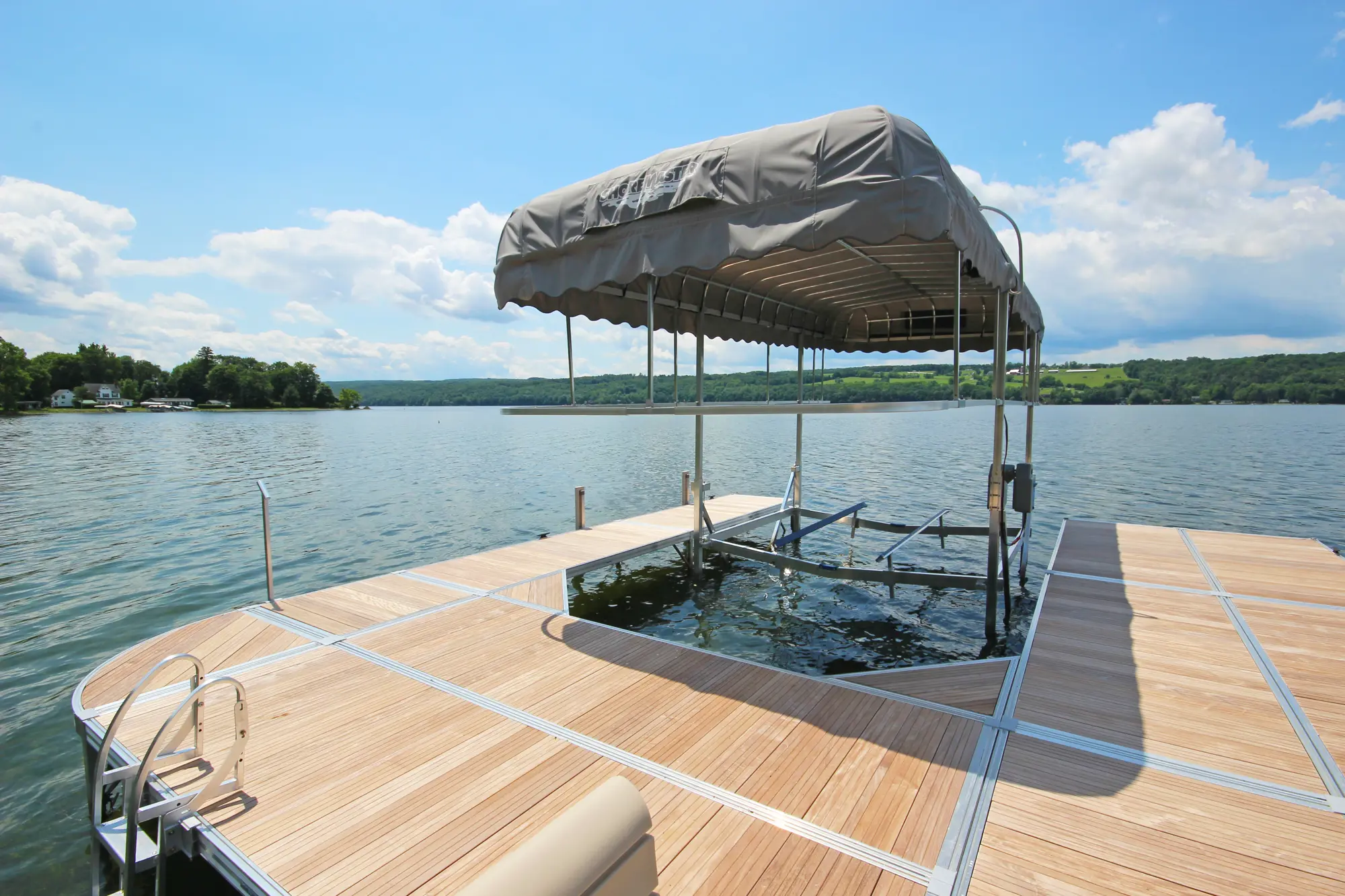 ShoreMaster boat lift installed beside a dock on a lake